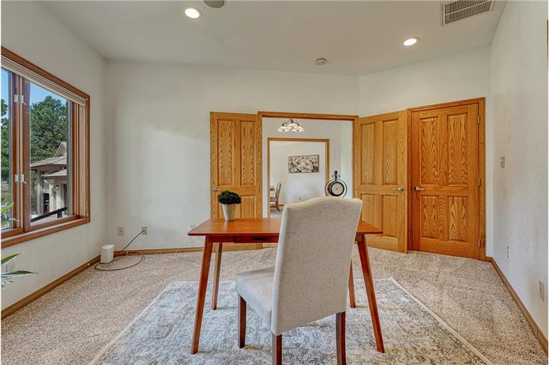 Double doors lead into the main level office with closet, recessed lighting, and in ceiling speakers.