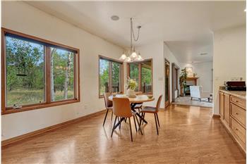 Bright breakfast nook looks out to the trees, so private!