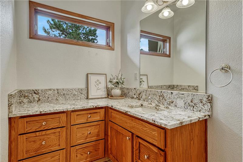 Main level powder room with granite counter.