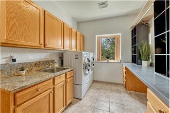 Main level laundry with granite counters, utility sink and a window. Washer/dryer are included!