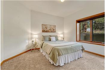 Lower level bedroom #3 with mirrored closet doors.