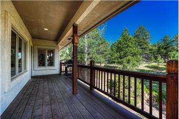 Covered wrap around wood deck.