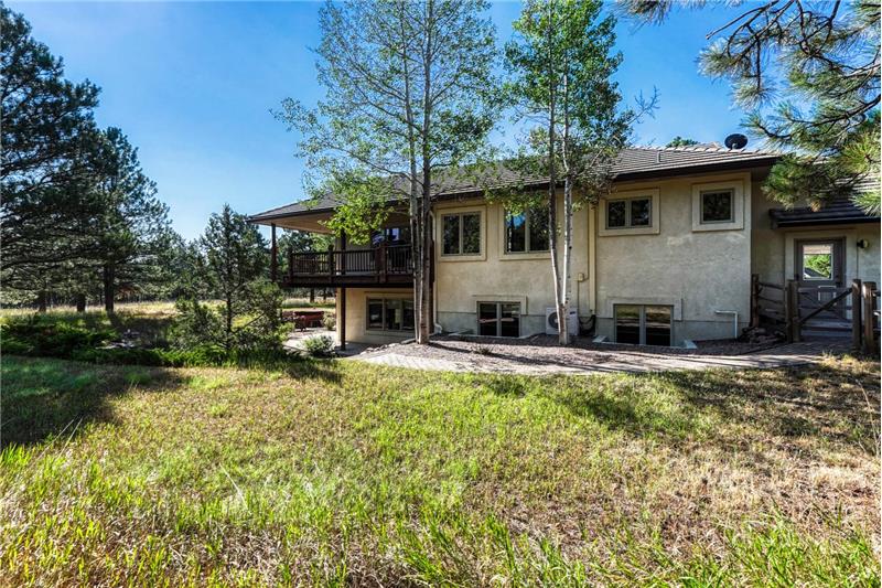 Back of the home and fenced in area for dogs.