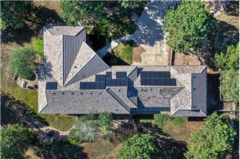 Aerial view showing the paid off solar and concrete tile roof.