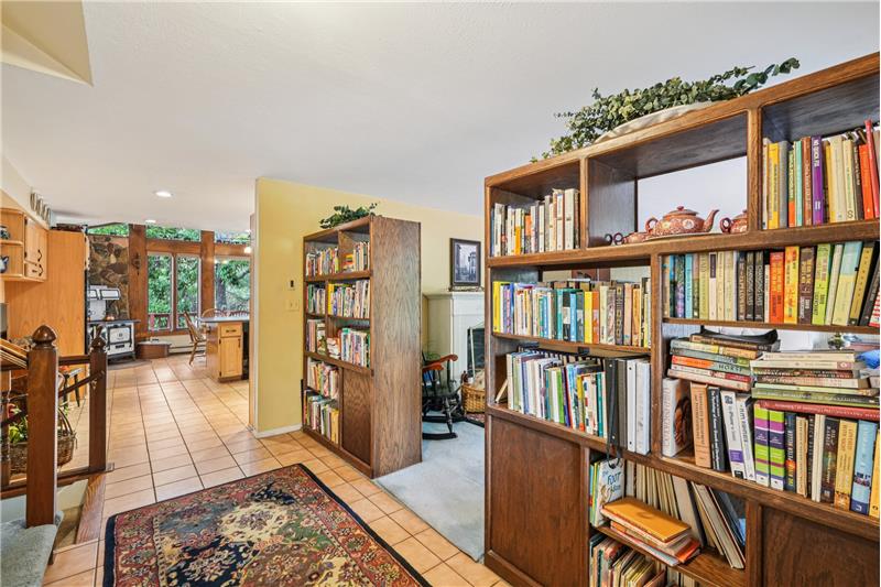 Foyer showing 2-sided bookshelves separating foyer from living room