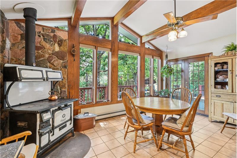 Addition to kitchen features vaulted ceiling and sunroom feeling