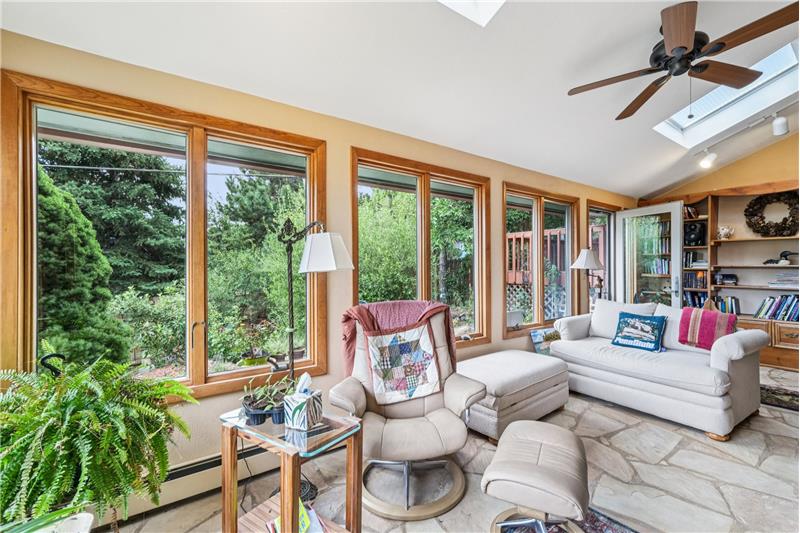 Sunroom is open to family room. Has 9 windows and 2 skylights.