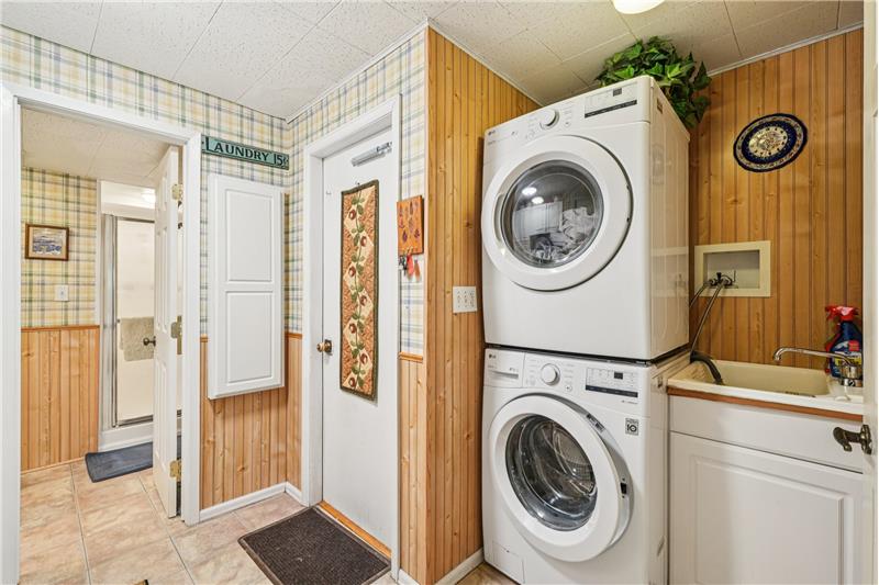 Laundry room is next to garage door and 3/4 bathroom. Machines included.