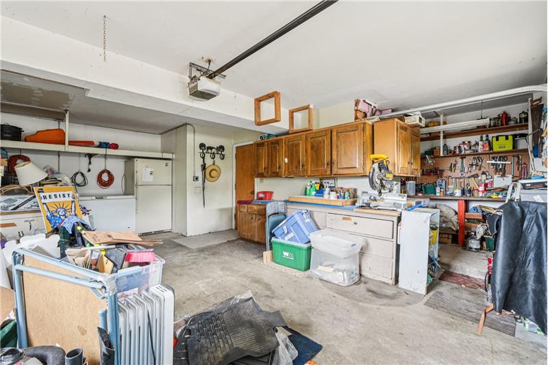 Garage includes freezer, refrigerator and workshop