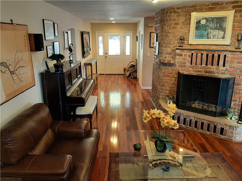 Enter and be comforted by 3/4 inch thick Brazilian Koa wood floors and classic brick.