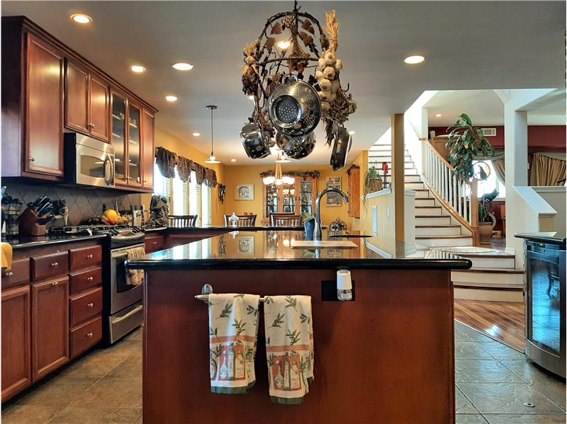 Impressive in scale, the powered island also features a versatile second sink supporting this Chef's Kitchen.