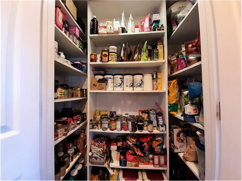 Value-added features of the home include this lighted Kitchen Pantry!