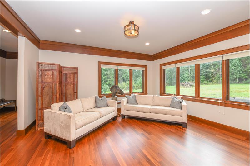 Living room off the sitting area. Picture windows and gleaming, recently refinished Brazilian cherry wood floors.