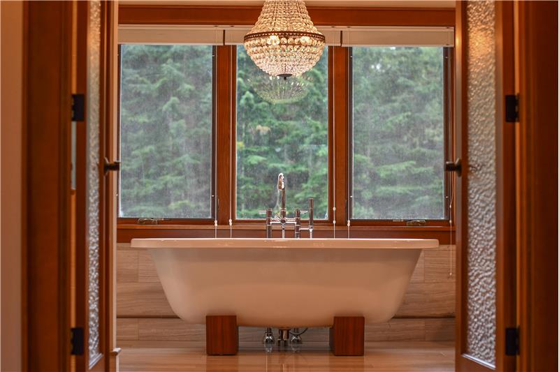 Primary bath to satisfy the most discerning of buyers. Genuine iron bathtub sits under the chandelier.