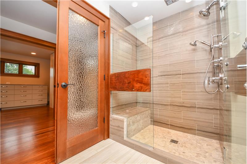 More of this luxurious primary bathroom. Don't want to take a bath? Step into the marble shower with multiple shower heads.