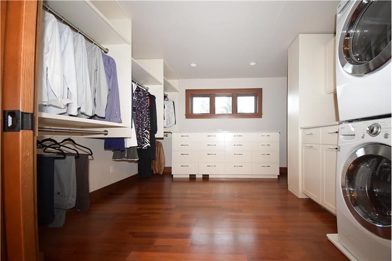 Primary closet with washer/dryer for ease. To the right of the cabinet under the window is a SHOE/BOOT Closet!