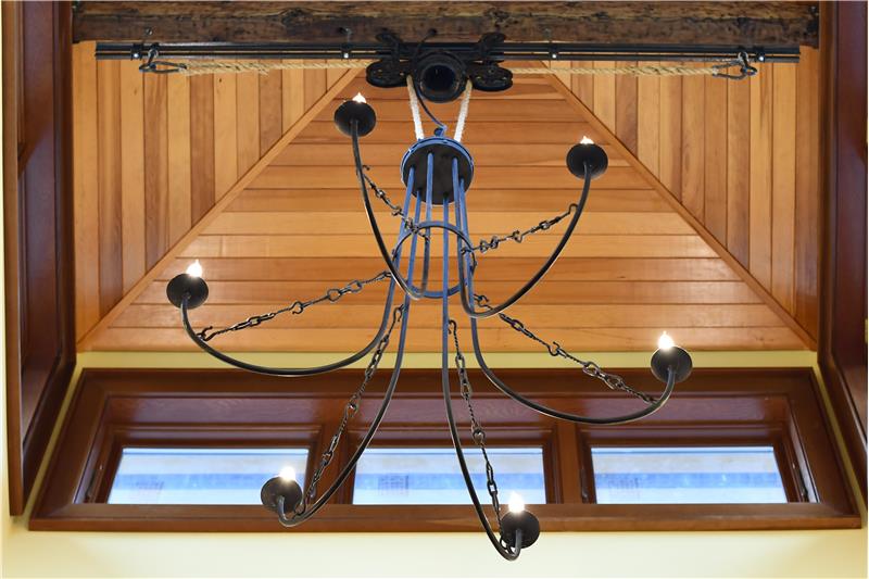 Custom, iron light from a Metalworking Artist in Leavenworth is on a beam of reclaimed wood.