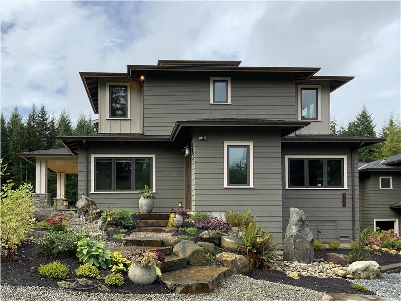 Showing of the significant architectural detail of this home. Low maintenance garden area with Montana Flagstone walkway.