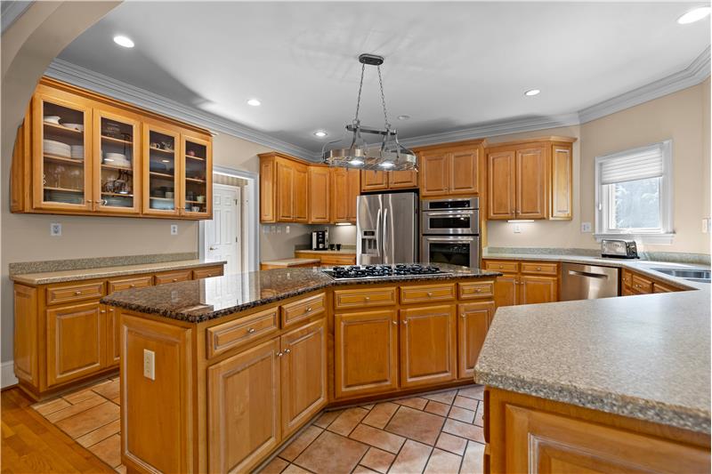 Kitchen features generous storage and counter-space, under-cabinet lighting, recessed lights, crown molding.