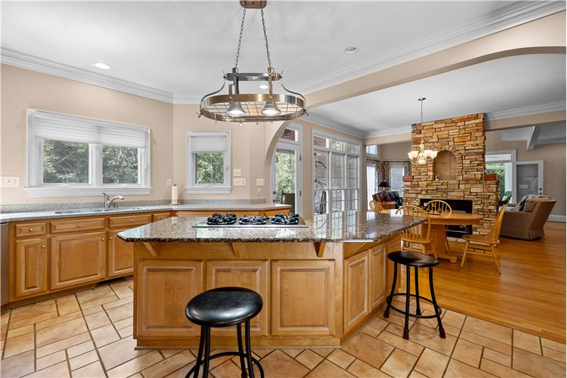 Kitchen island with generous seating. Open sight lines to breakfast area.