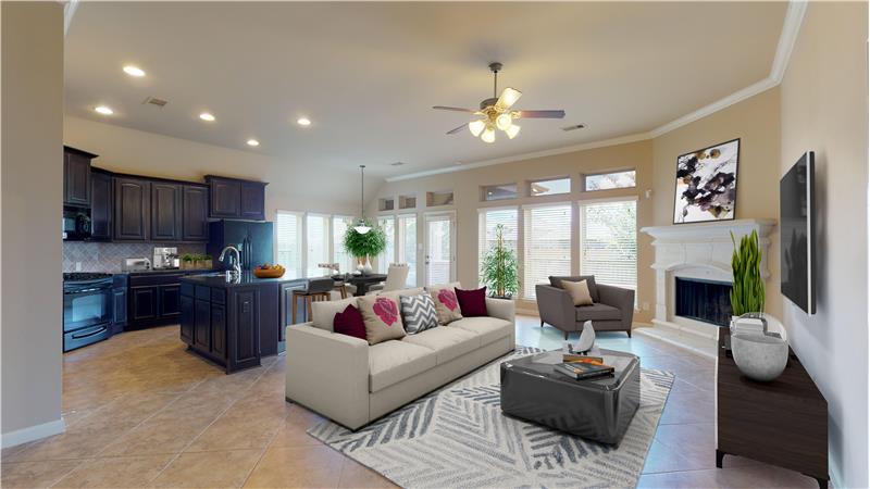 The tile floored family room features a corner fireplace and is open to the kitchen and breakfast area.