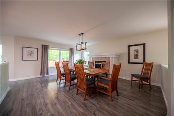 Huge dining room fits a huge table, complete with fireplace.
