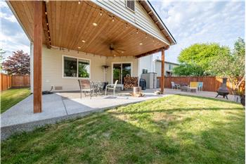 Covered patio with built in lighting and ceiling fan.