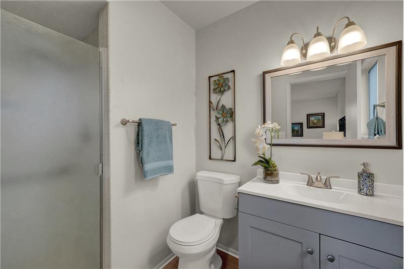 Primary Owner's Shower Bathroom with new vanity, countertops, mirror, lights, & toilet