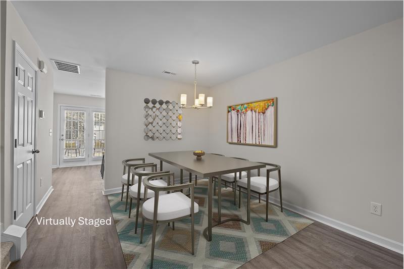 Dining area with new light fixture is ideal for both casual meals and entertaining.