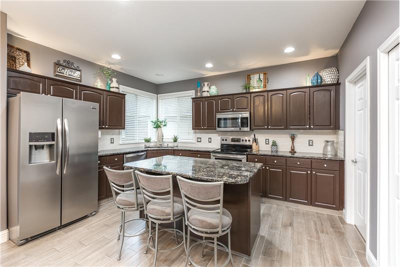 Chef's Kitchen with Granite Counter Tops, Center Island, Stainless Steel Appliances, Subway Tile Backsplash, Freshly Painted Kit
