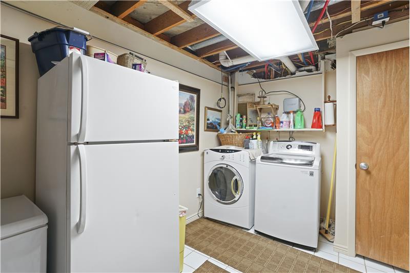 Shared laundry room is accessed from both the family room and the mother-in-law apartment