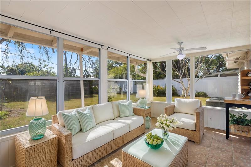 This photo is virtually staged to show as a relaxing Sunroom