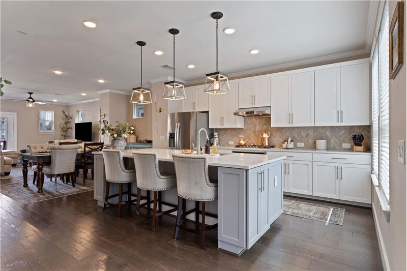 Designer fixtures, Quartz tops, Accent walls, Fresh interior paint, Wood floors in living areas.