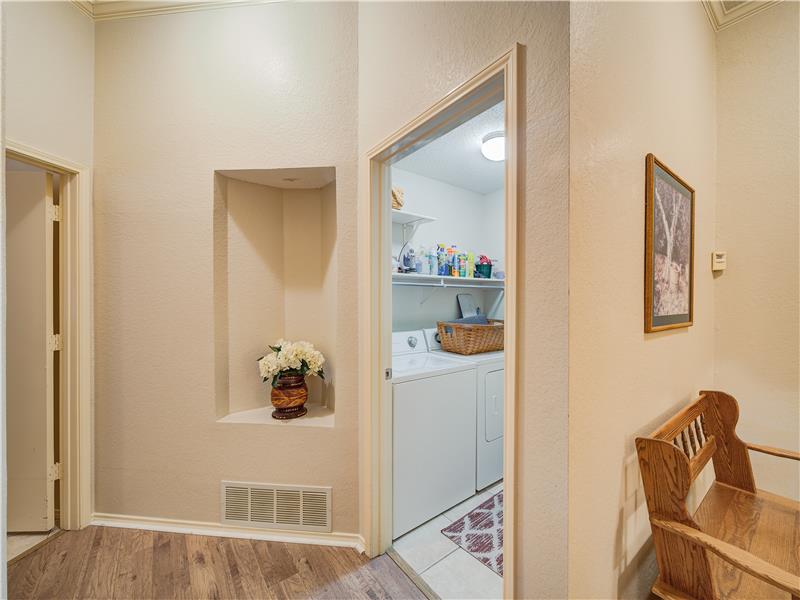 Corridor with light hardwood / wood-style flooring and washer and clothes dryer