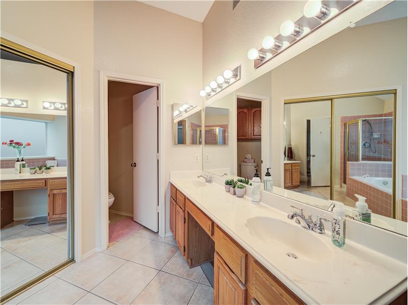 Bathroom featuring a bathing tub, toilet, oversized vanity, and tile flooring