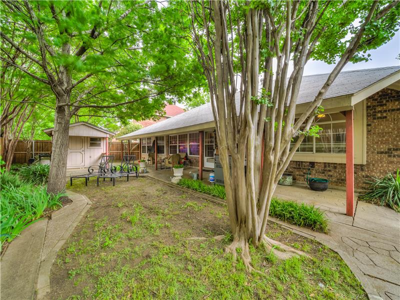 View of yard featuring a shed and a patio area