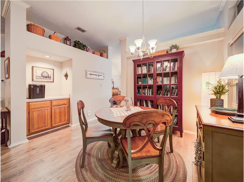 Dining room featuring light hardwood / wood-style floors, an inviting chandelier, and crown molding