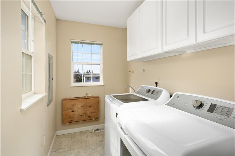 Nicely sized laundry room could be converted to an additional bath by moving the washer/dryer to the adjacent knockout in the ha