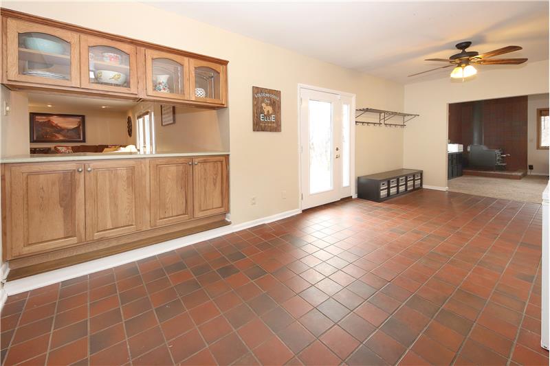 Large mud room with access to the attached 2-car garage and walk-out to the backyard. Perfect space to use for your drop zone!