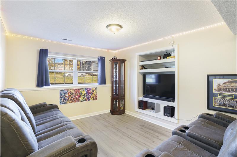 Finished lower level family room with build in entertainment center