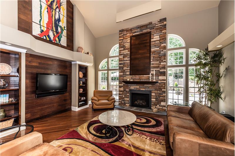Stunning, 2-story great room with custom-built, floor-to-ceiling gas log fireplace.