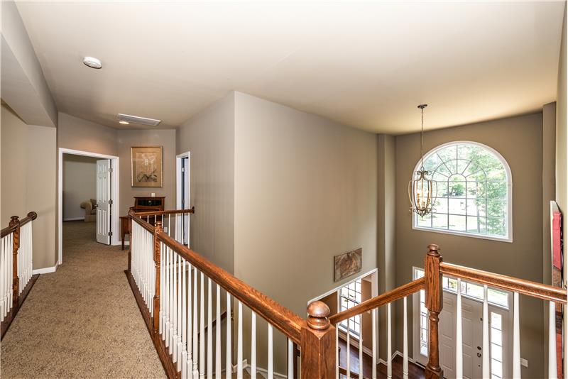 Second floor landing/cat walk provides views to the foyer and the great room. Accessed via double, split staircase.