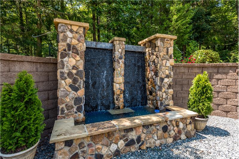 Custom-built, stone waterfall feature is a special focal point in the backyard.