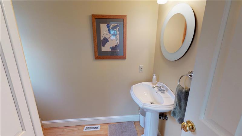 This half bath, located close to the stairs, was recently painted in a soft, neutral tone!