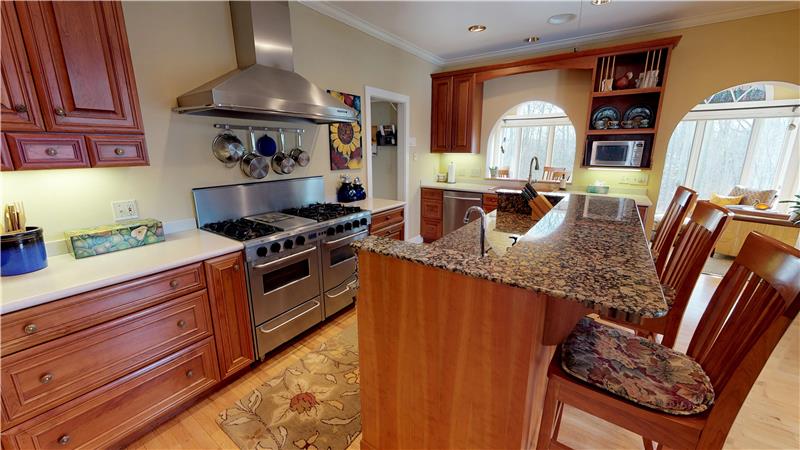 Enjoy meal prep and entertaining in this gorgeous kitchen with corian and granite tops, hardwood floors and access to the porch!