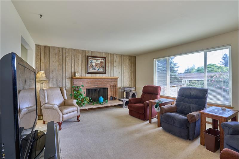 Cozy Living Room with Brick Surround Wood Burning Fireplace