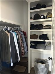 Walk in closet with shelving in master bath