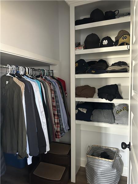 Walk in closet with shelving in master bath