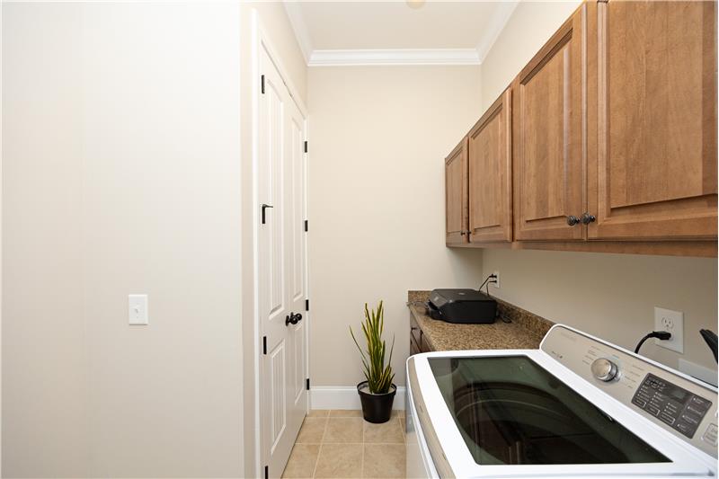 Laundry Room with Built-In Cabinets and Linen Closet