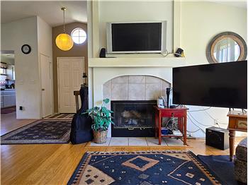 Warm living area with fireplace in a highly desirable gated Santa Maria community.